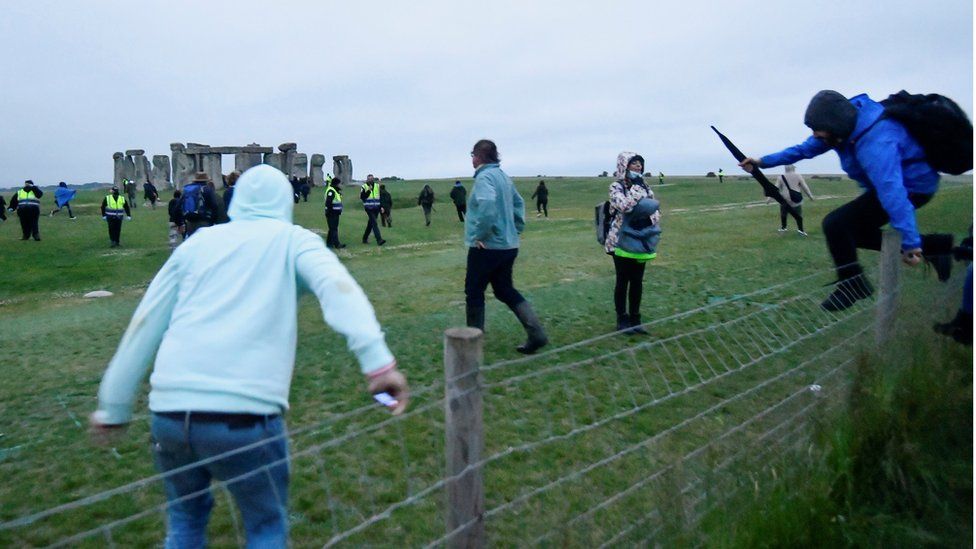 Solstice rule-breakers climb fence